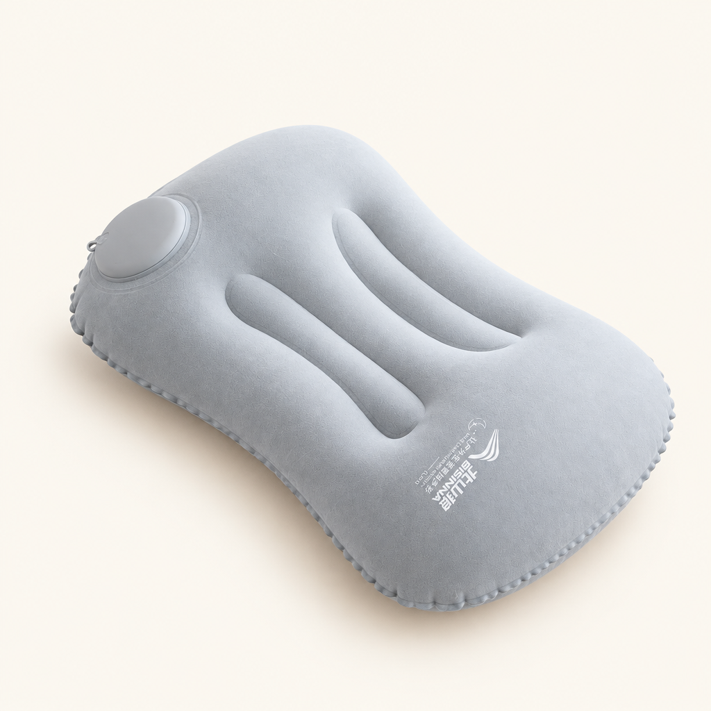 Grey inflatable travel pillow on a light studio background